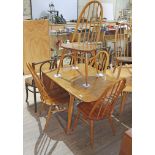 An Ercol blonde elm drop leaf table and four spindle back chairs, max length 138cm, width 74cm.