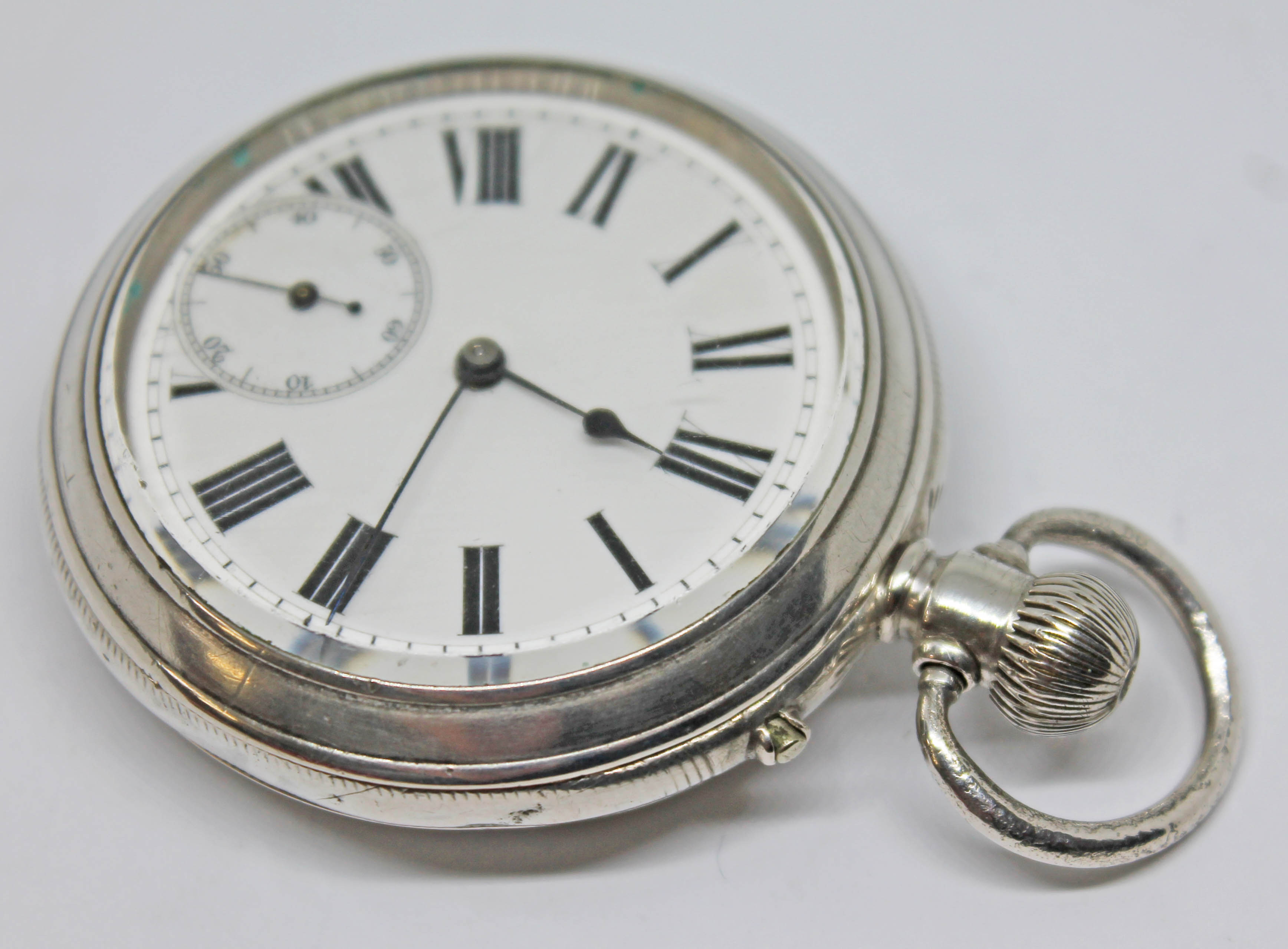 A silver cased Baume & Co pocket watch with white enamel dial, Roman numerals, spade hands and