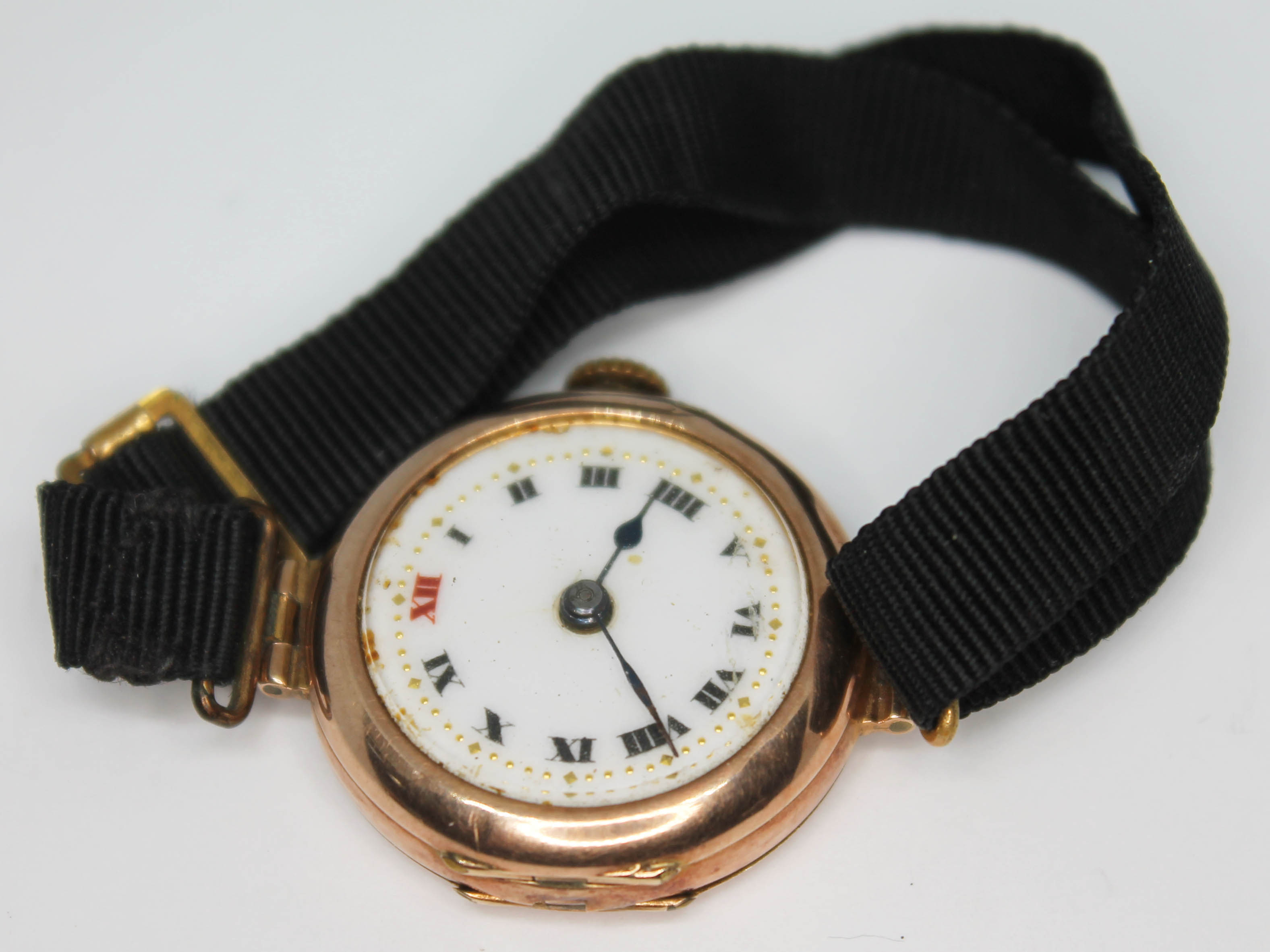 A ladies 9ct gold wristwatch with enamel dial, case diam. 25mm, with ribbon type strap, gross wt.