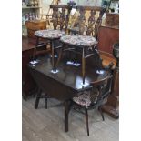 An Ercol dark elm drop leaf table and four fleur de lys back chairs, max length 123cm, width