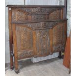 A profusely carved mahogany double bedstead. Condition: no signs of any major damage or repairs, old