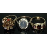 A group of three dress rings comprising one hallmarked 9ct gold and random set with opals and red