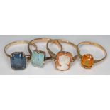 A group of four rings comprising a hallmarked 9ct gold ring set with blue paste, three other rings