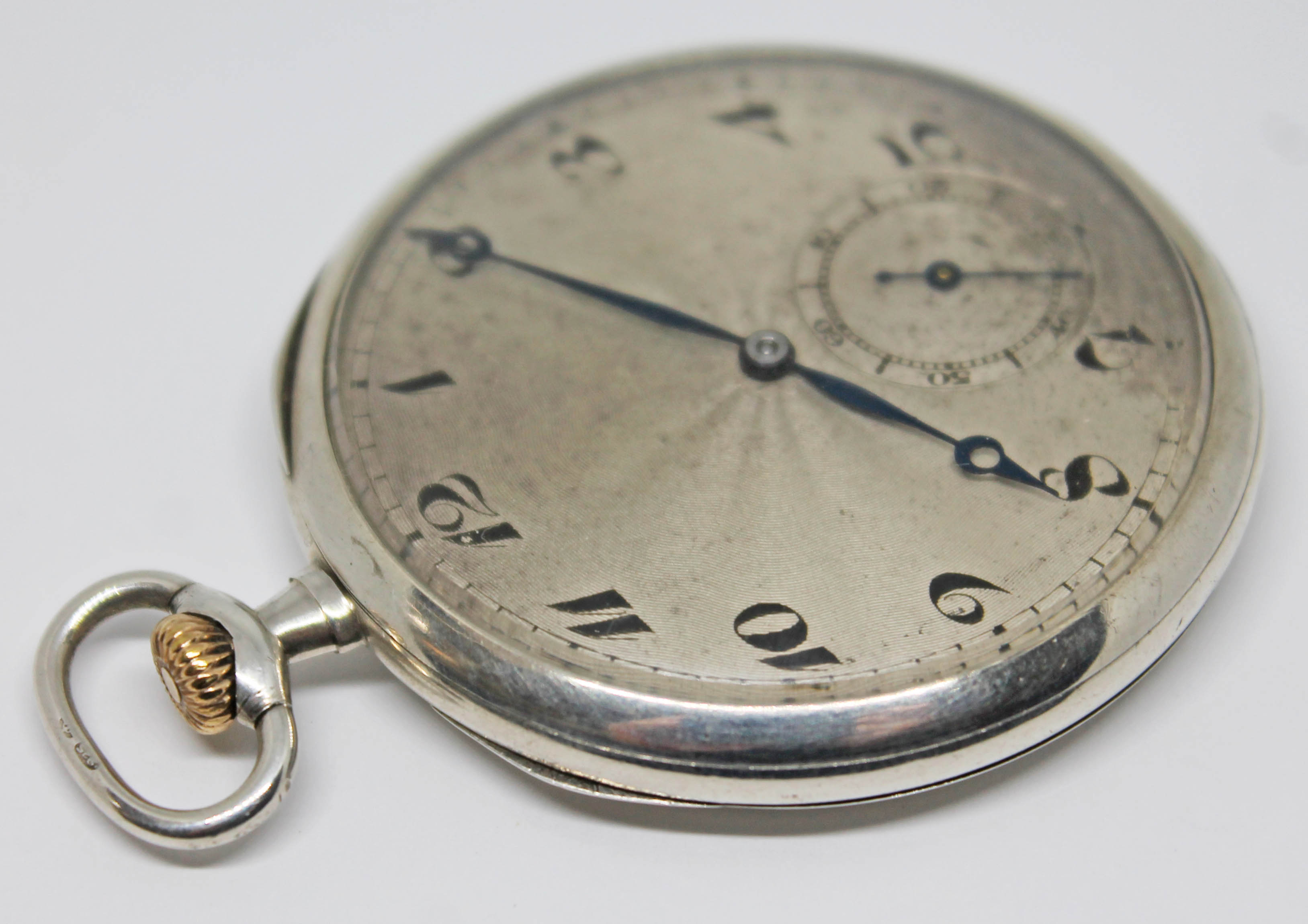 A 1920s silver cased pocket watch with silver tone guilloche dial, Arabic numerals and breguet hands