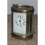 A late 19th century French brass carriage clock of oval form, 12.5cm. Condition: not currently