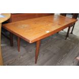 A Gordon Russell teak long coffee table on tapered legs, height 40cm length 121cm. Condition: cup