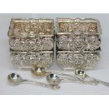 A set of four hallmarked silver salts, two with matching spoons, wt. 4 3/4oz.