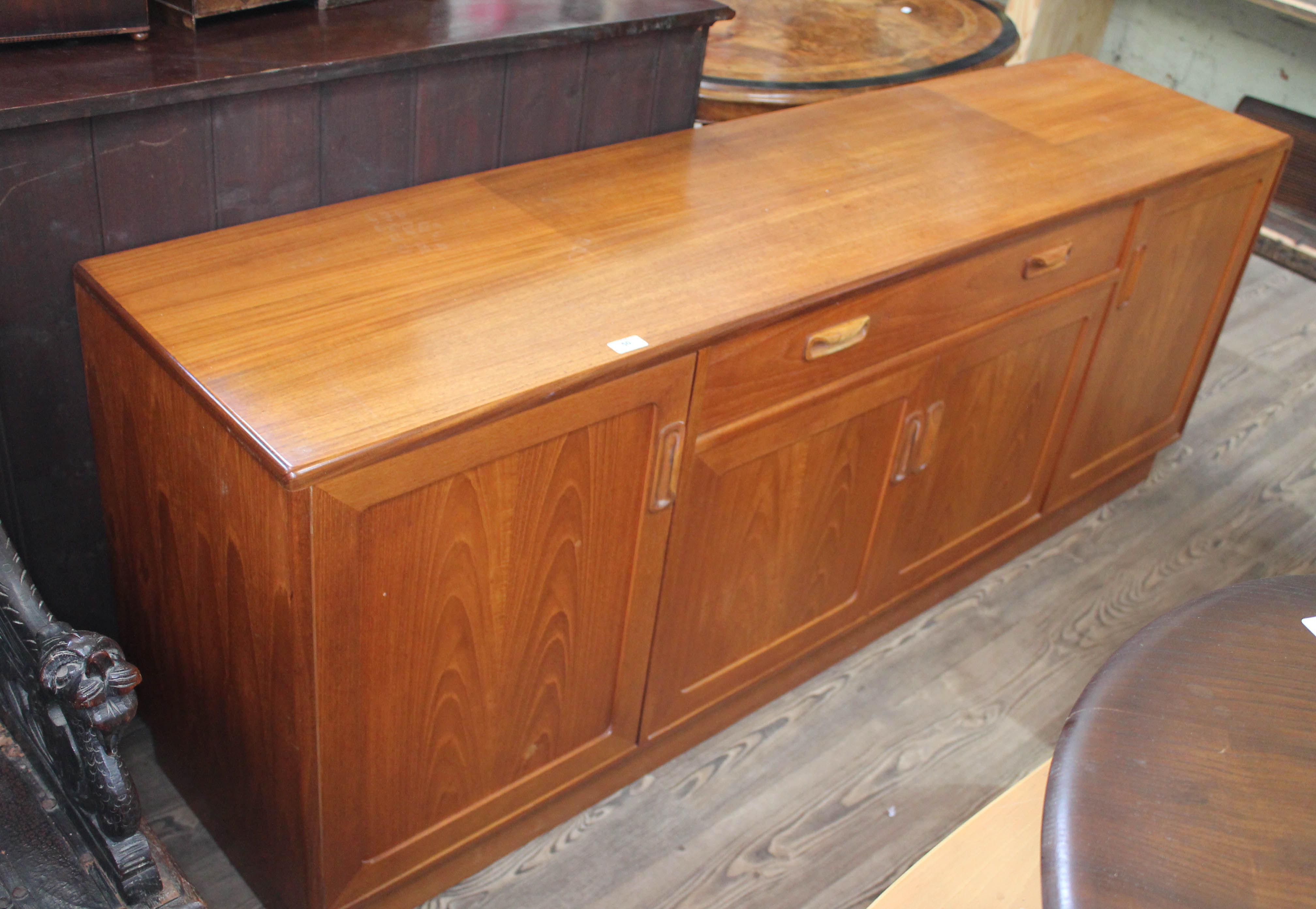 A G-Plan teak sideboard base having central twin handled drawer with cutlery tray over a double door