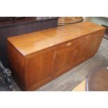A G-Plan teak sideboard base having central twin handled drawer with cutlery tray over a double door