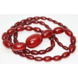 A single strand of graduated cherry bakelite beads, ranging from 10mm to 26mm, total length 74cm,