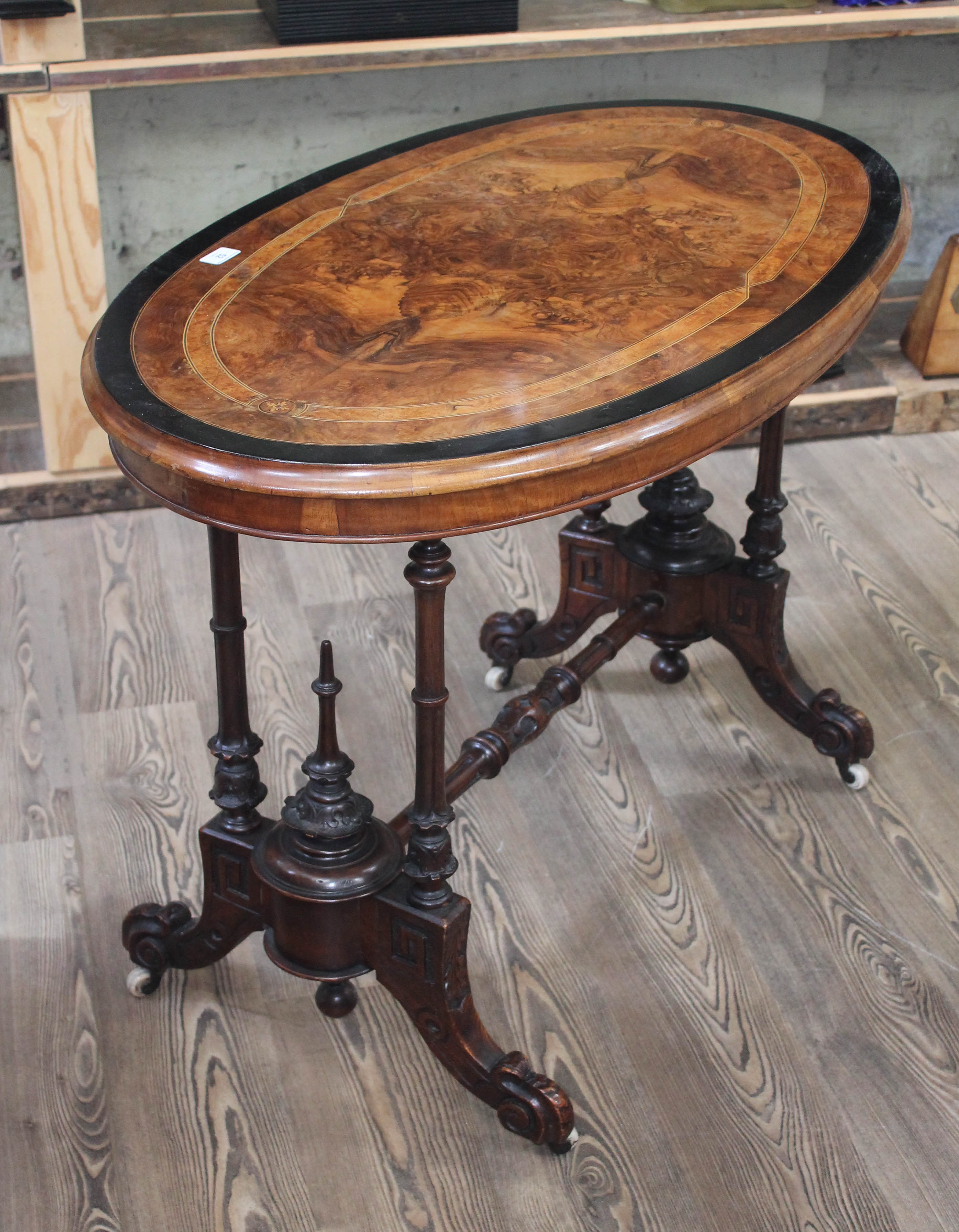 A Victorian walnut cross banded and inlaid oval occasional table with quarter veneered figured top