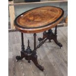 A Victorian walnut cross banded and inlaid oval occasional table with quarter veneered figured top