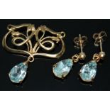 A modern Art Nouveau style drop pendant set with a pear cut blue topaz and a pair of matching