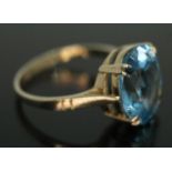 A dress ring set with an oval cut blue synthetic blue spinel, measuring approx. 12mm x 10mm x 5mm,