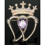 A Scottish silver silver brooch set with an oval cut amethyst, length 35mm.