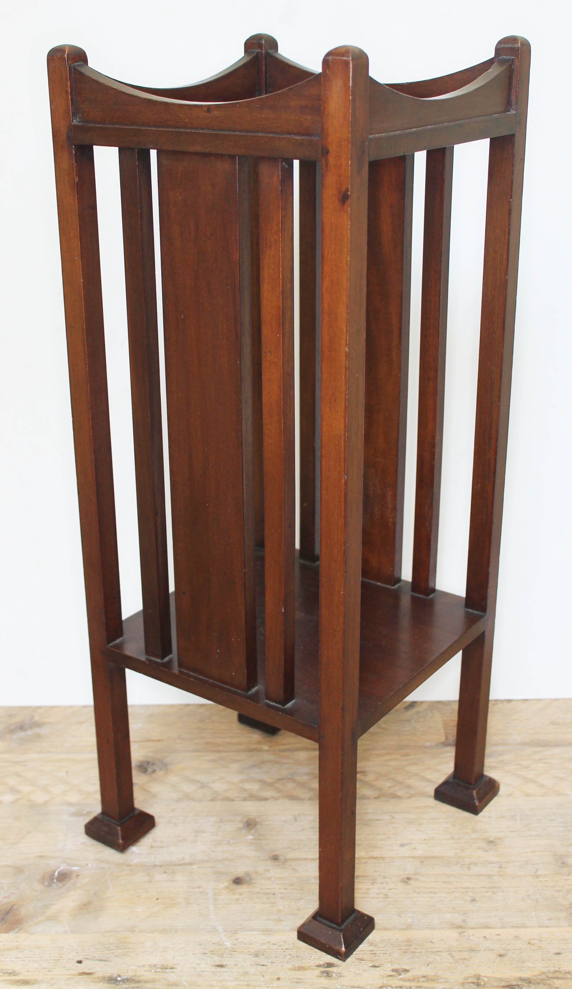An Edwardian Arts & Crafts style mahogany plant stand with slatted sides, lower tier, on squared