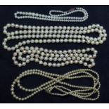 Three strands of cultured pearls, together with a simulated pearl necklace with clasp marked '585'.