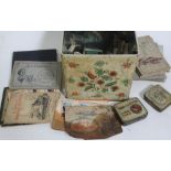 A tin of cigarette cards and coins.