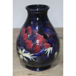 A Moorcroft pottery vase, height 19cm. Condition - good, no damage/repair, minor wear only.