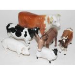 A group of six Beswick animals comprising two cows, a bull, a pig, a sheep and a donkey. Condition -