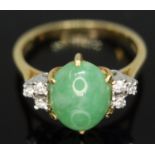 A diamond and jade cabochon ring, the central jadeite jade cabochon measuring approx. 9mm x 8mm x
