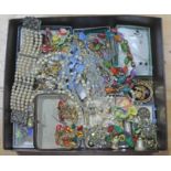 A box of vintage costume jewellery including stickpins etc.