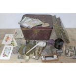 A tin and contents including books, a nurses belt, a clap pipe, watches, metal ware, trench art, a