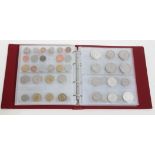 A coin album containing mainly world 20th century including a United States 1922 dollar,