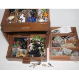 Wooden drawers of costume jewellery.