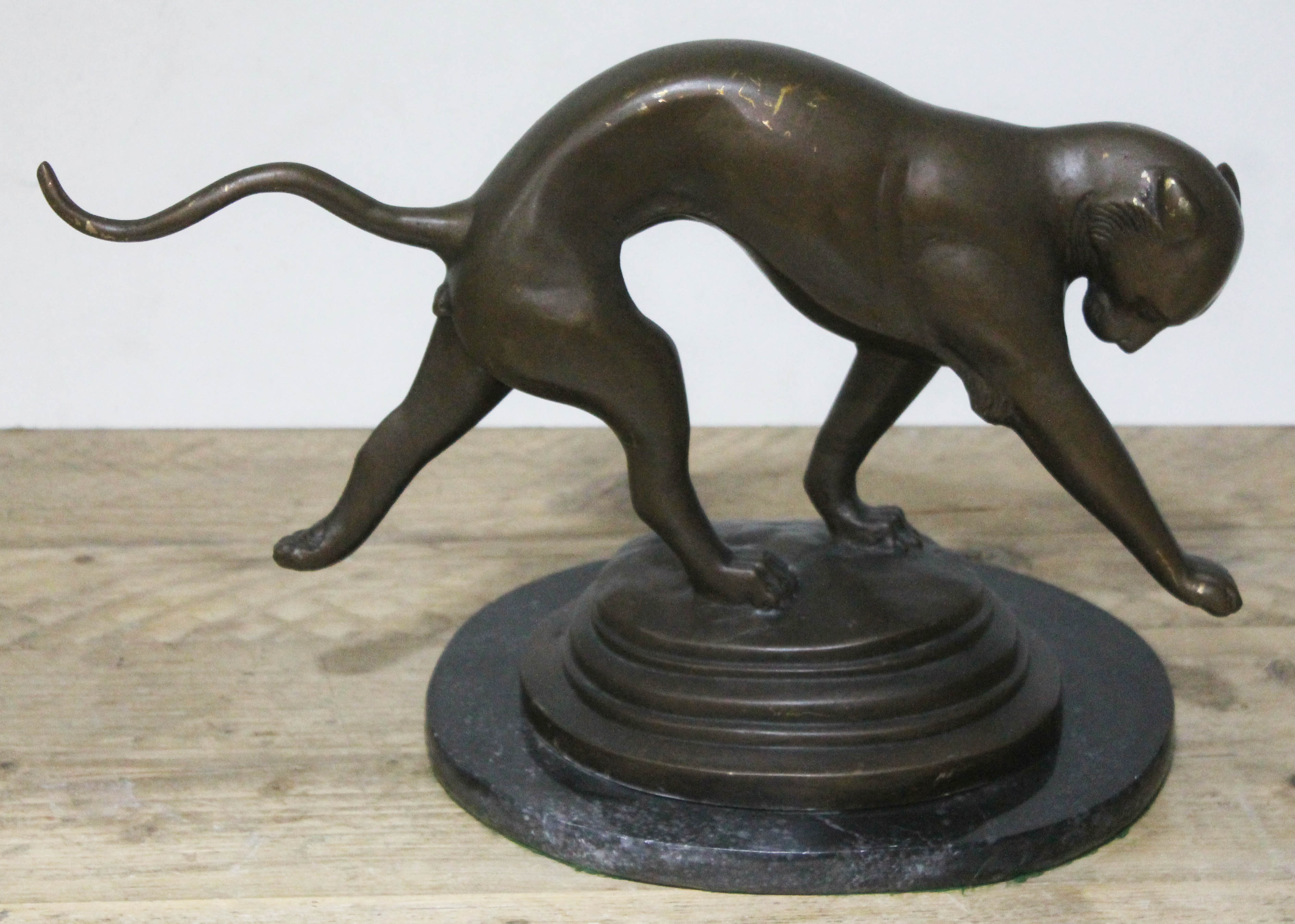 A modern Art Deco style bronzed finish panther on marble plinth, length 45cm.