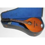 A flat back mandolin with case.