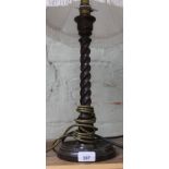 A 1920s twist oak table lamp with shade, height 57cm.