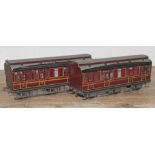 A pair of kit built 0 gauge maroon coaches.