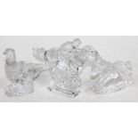 Three pieces of Waterford glass comprising a horse and jockey, a rocking horse and a pheasant.