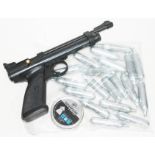 A Crosman 2240 .22 air pistol with CO2 canisters and pellets.