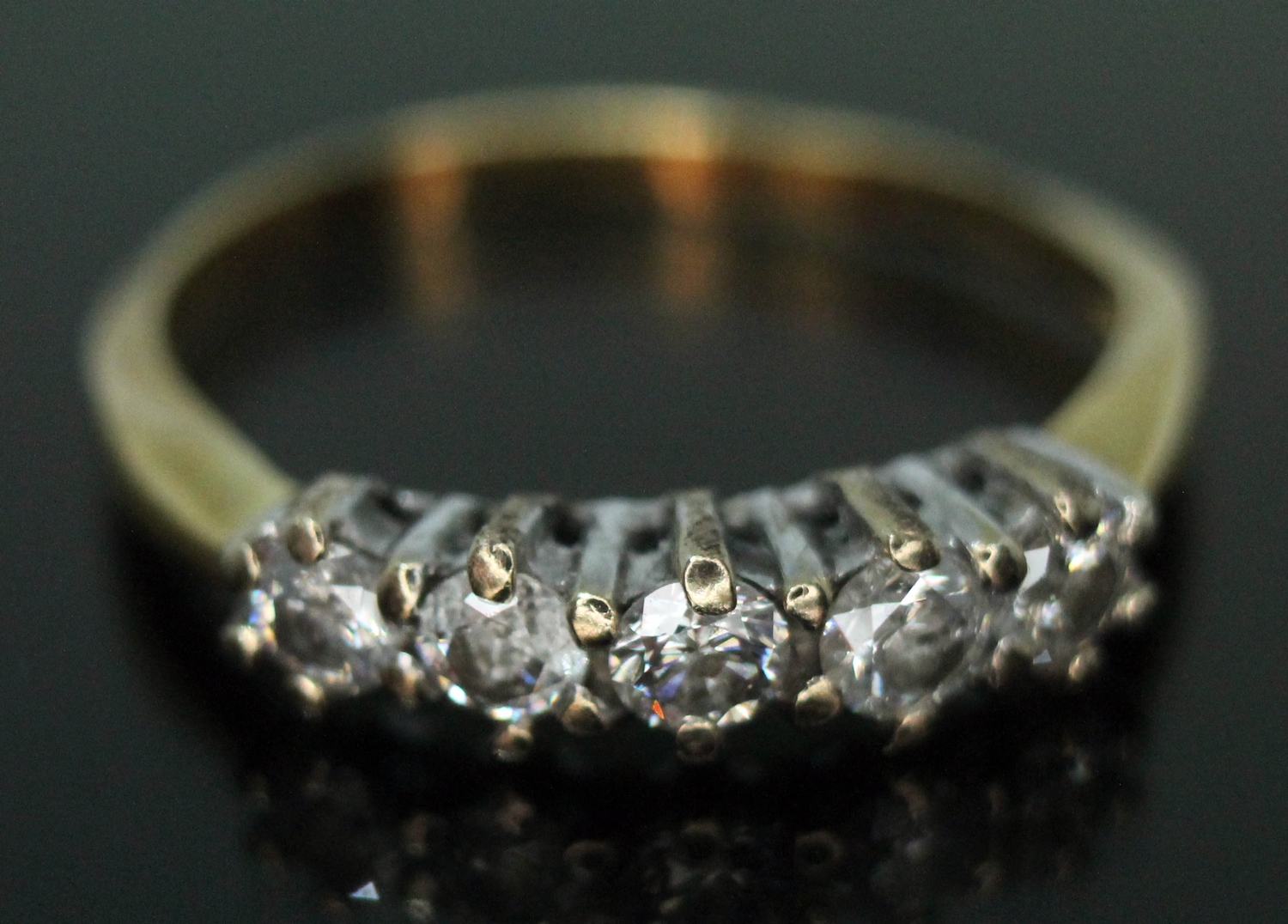 A five stone diamond ring, 18ct gold import marks, gross wt. 2.03g, size K (band bent).