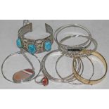 A mixed lot including silver bangles, an eastern bangle set with 'scarab beetles', a rolled gold