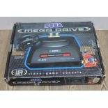 A Sega Megadrive II, in original box, with 2 controllers and power lead. Box also includes