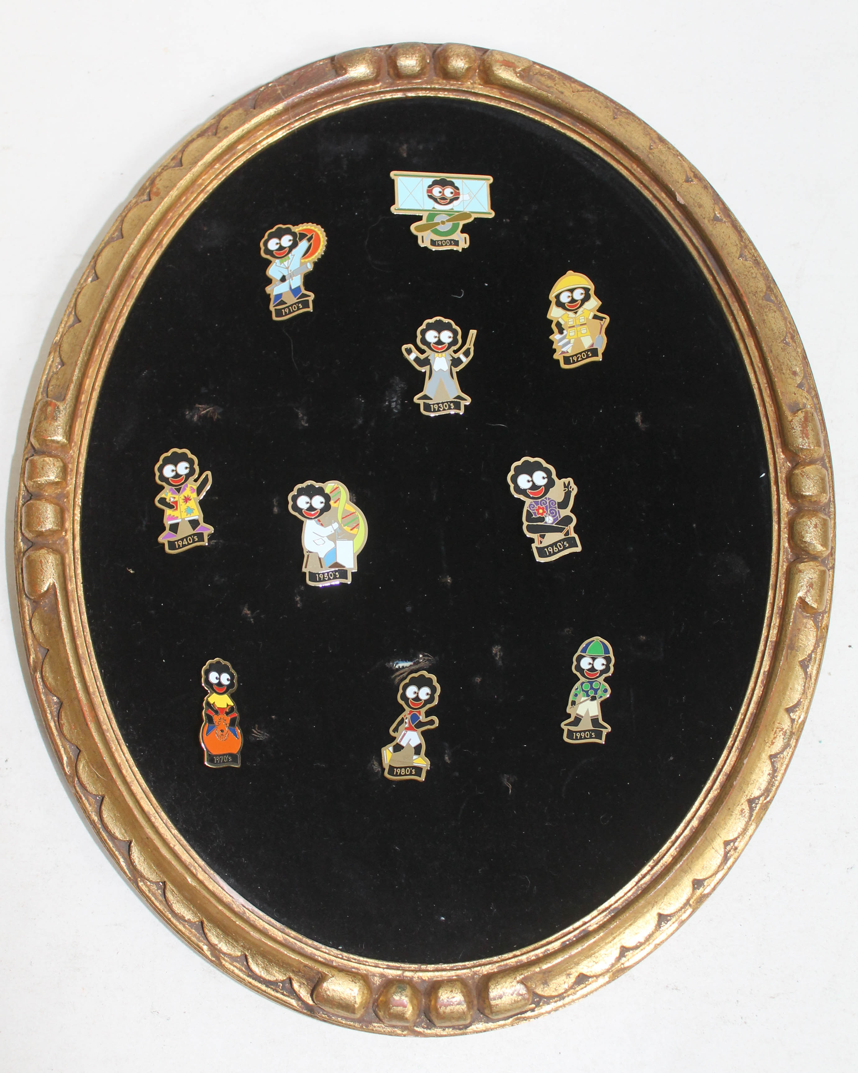 A set of ten golly badges in frame.