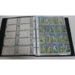 An album containing ten complete sets of cigarette cards.