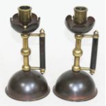 A pair of Arts & Crafts brass and copper candlesticks after Christopher Dresser/Benham & Froud,