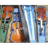 Three vintage violins in hard cases, all in various condition. 1. 2. Copy of Amati made in Saxony 1.