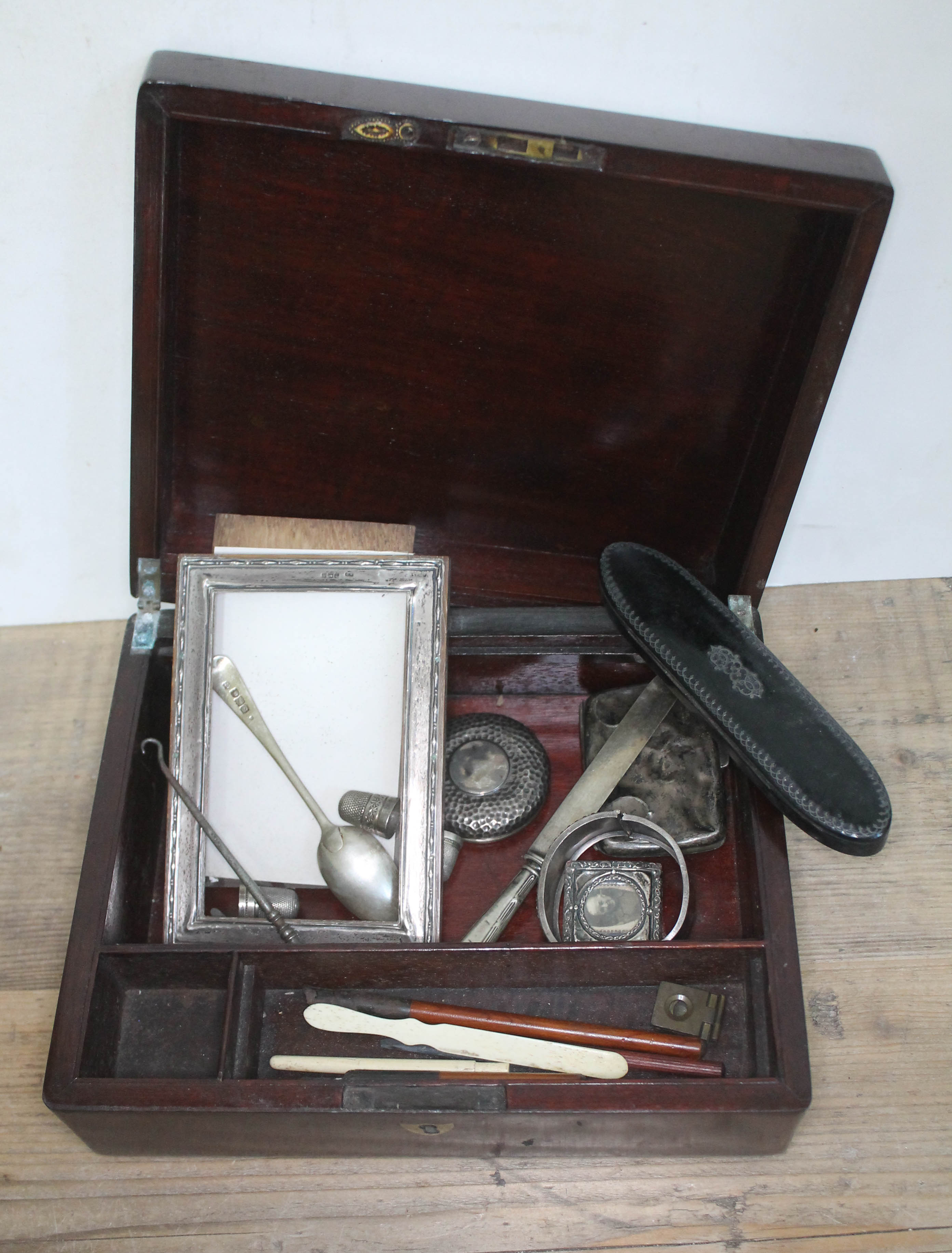 A 19th century mahogany box and contents comprising mainly hallmarked silver, a spectacle case etc.
