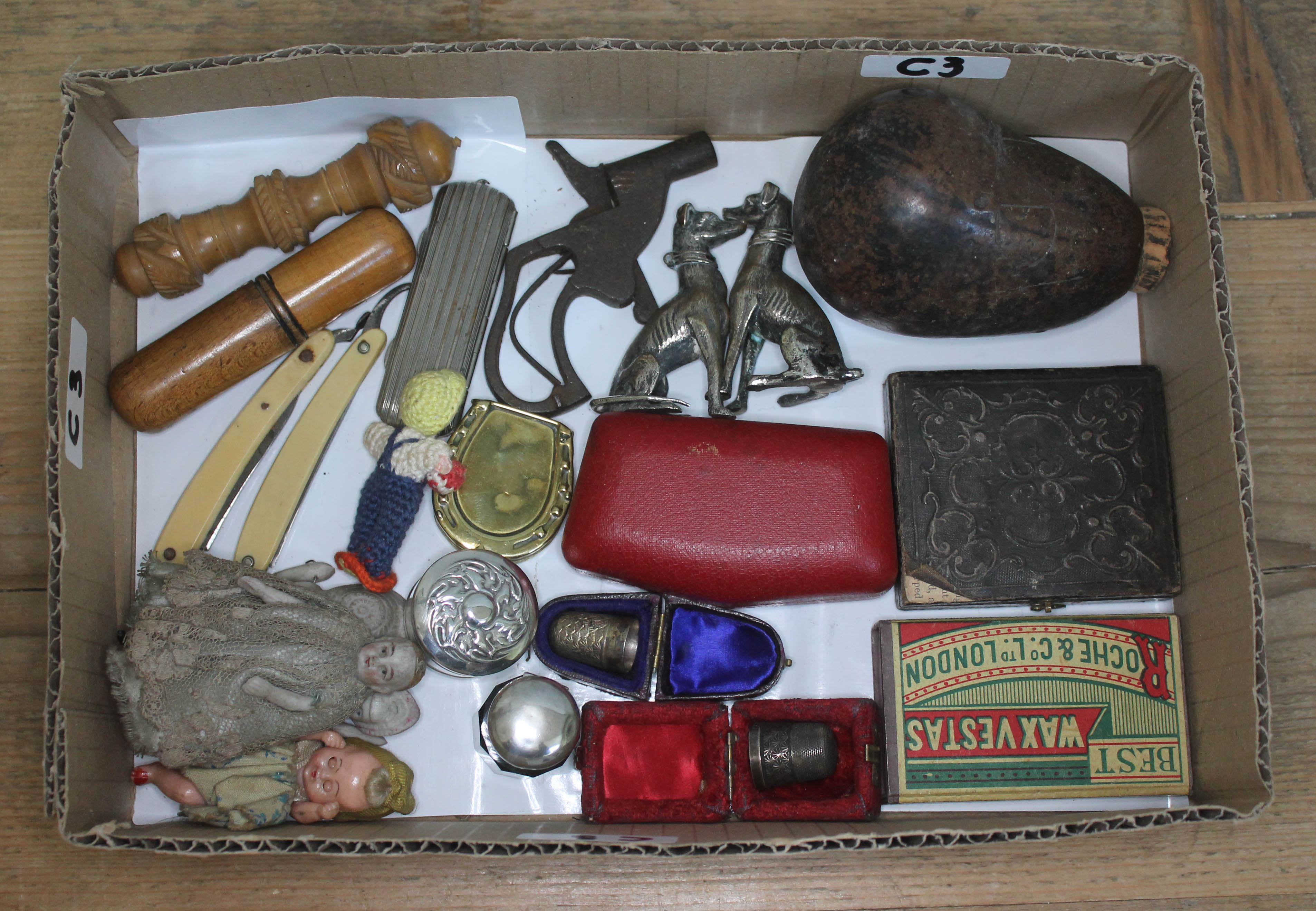A tray of bric a brac including a vegetable ivory needle case, a level in treen case, two hallmarked