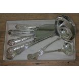 A mixed lot comprising four hallmarked silver handle knives, a pair of hallmarked silver sugar tongs