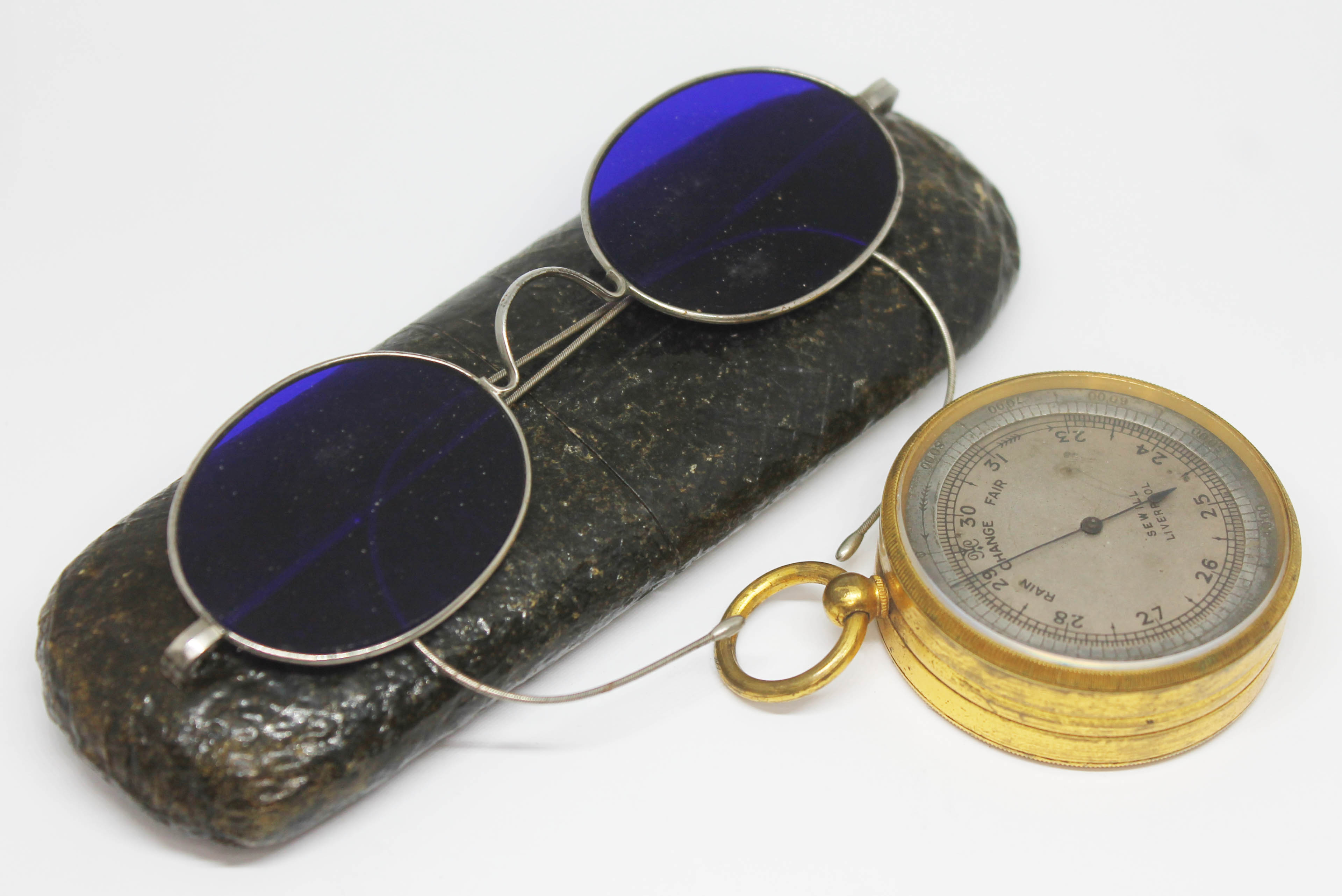 A 19th century git brass cased pocket barometer signed 'Sewill Liverpool' and a pair of blue lens