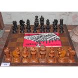 A box wood and ebonised chess set with board.