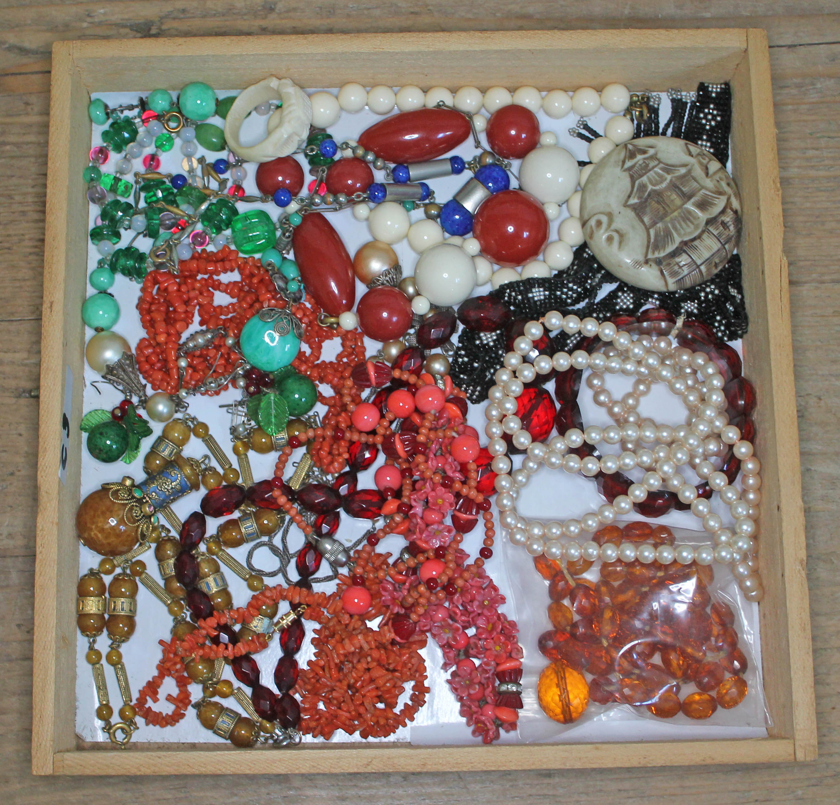 A mixed lot of costume jewellery including coral, bakelite, amber etc.