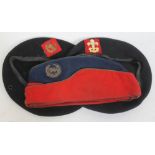 Three military caps with badges.