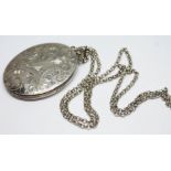 A hallmarked silver bright cut engraved locket on unmarked chain.